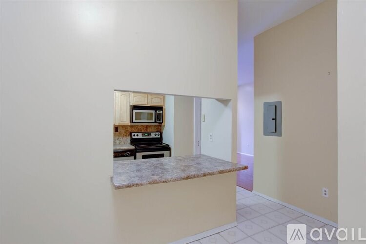 A kitchen area with a countertop and a microwave.