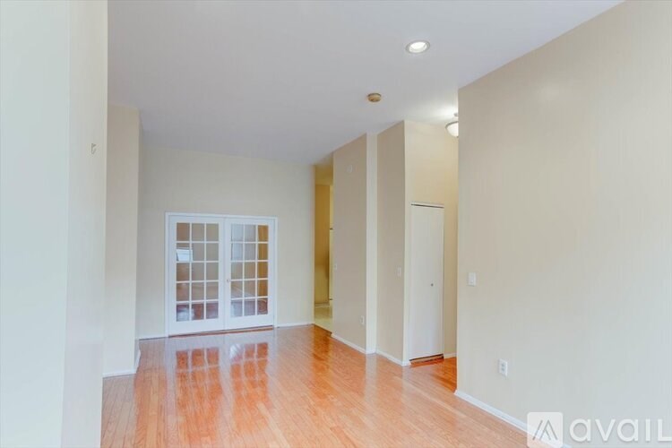 A room with wooden floors and a glass door.