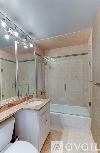 A bathroom with a toilet, sink, and bathtub.