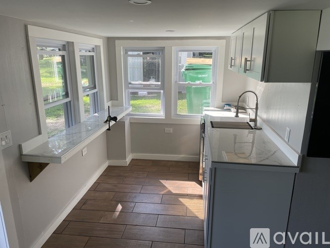 A kitchen with a table and chairs in the middle of it.