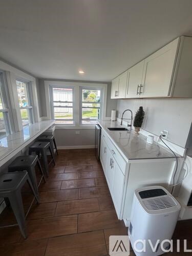 A kitchen with a table and chairs in the middle of it.