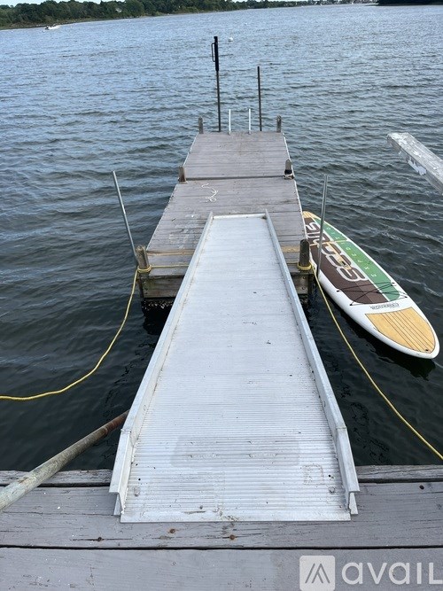 A living room with wooden floors and a white fireplace.