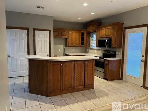 A kitchen with wooden cabinets and a white countertop.