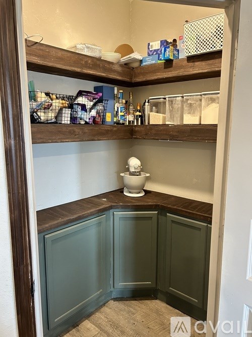 A bathroom with a toilet and a shelf above it.