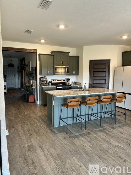 A kitchen with a bar stool and a counter.