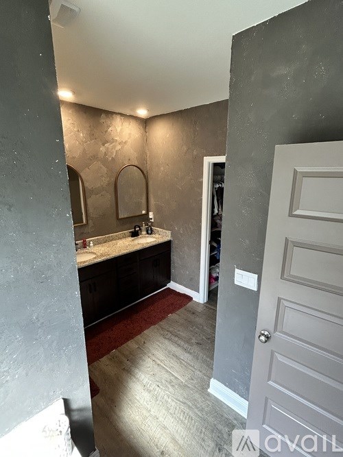 A bathroom with a sink and mirror.
