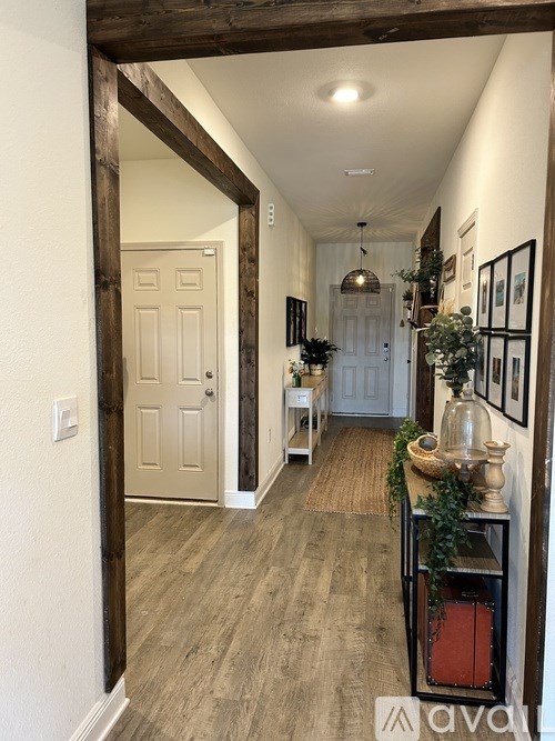 A hallway with a white door and a wooden frame.