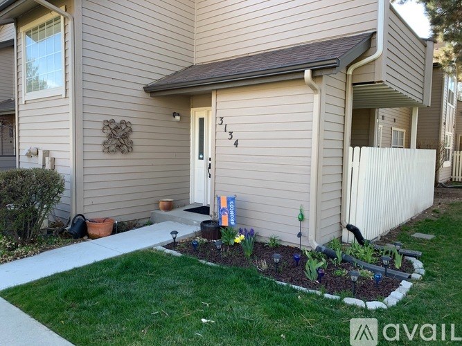 A house numbered 314 has a small front yard with a flower bed.
