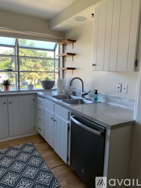 A kitchen with a sink and a window.