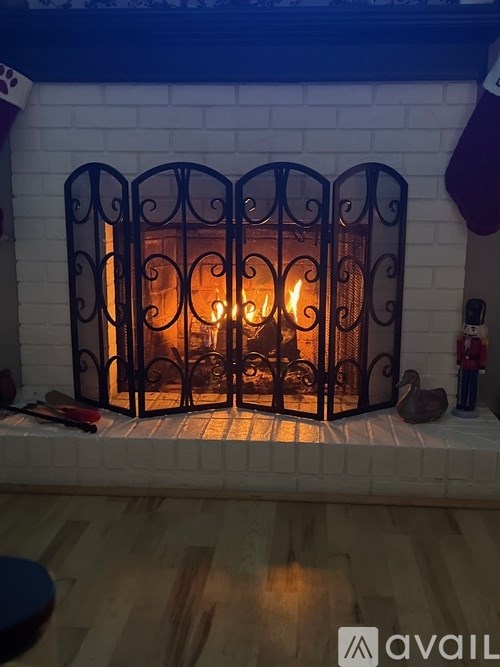 A fireplace with a fire burning inside.