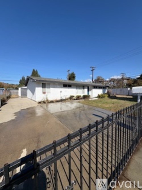 A skate park with a ramp and a fence.