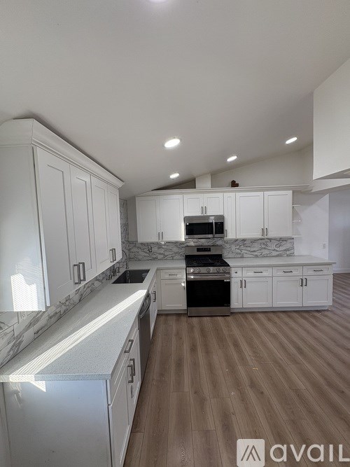 A living room with a fireplace, two chairs, a couch, and a coffee table.