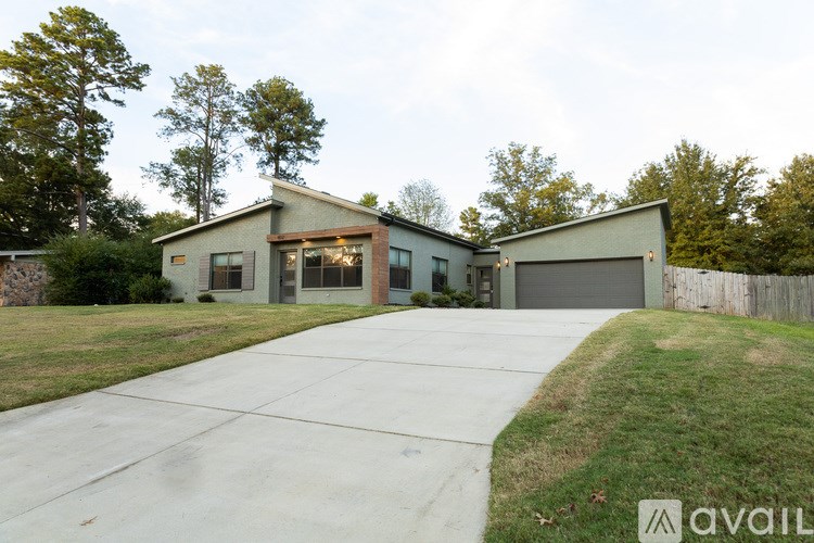 A modern house with a large driveway and a garage.