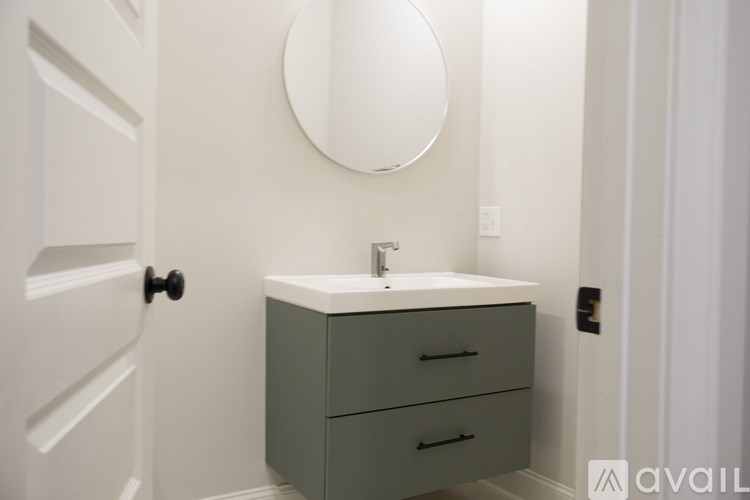 A bathroom with a sink and a mirror.