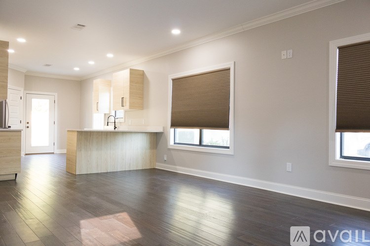 A spacious kitchen with wooden floors and a large island.