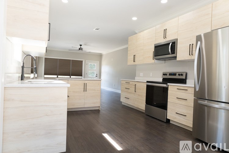 A modern kitchen with wooden cabinets and stainless steel appliances.