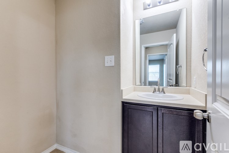 A bathroom with a sink and mirror.