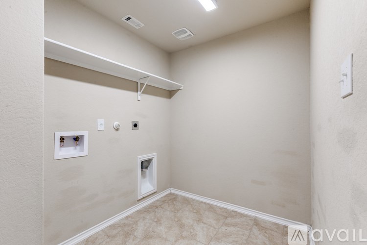 A room with a white wall and a white ceiling with a light fixture.