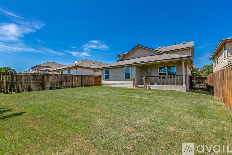 A house with a fence and a yard is available for sale.
