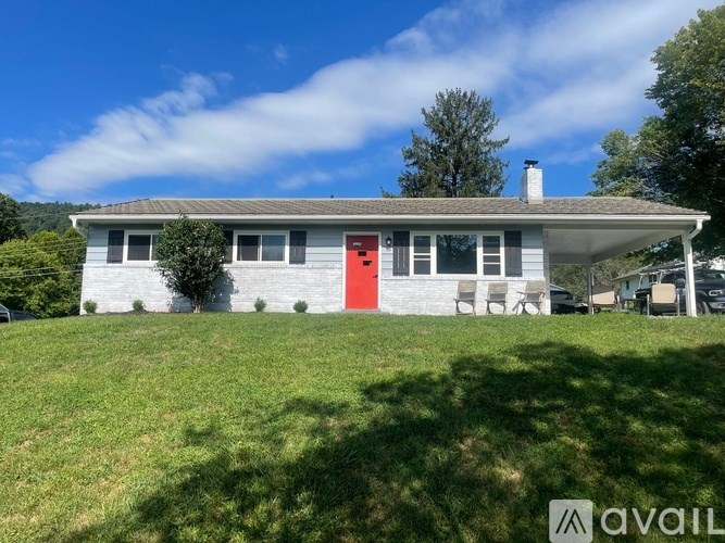 A house with a red door is for sale.