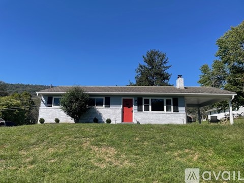 A house with a red door is for sale.