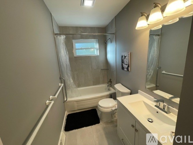 A bathroom with a toilet, sink, and bathtub.