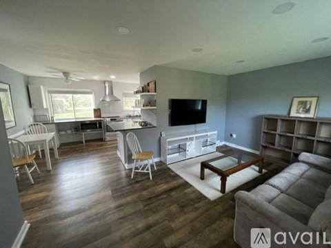 A living room with a grey couch and a wooden coffee table.