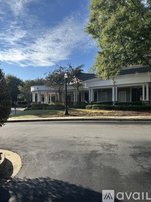A white house with a tree in front of it.