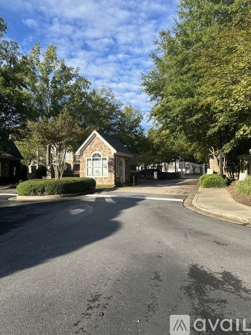 A street view with a house and trees on the side.