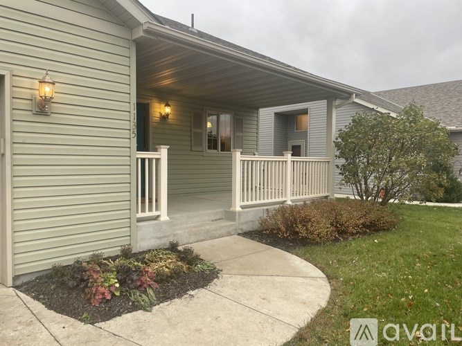 A house with a front porch and a small garden.