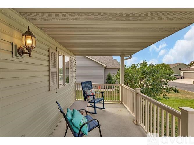 A porch with a bench and a lantern on the wall.