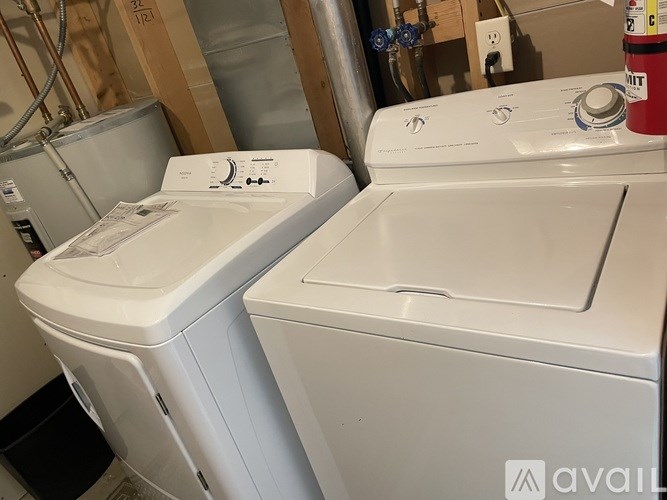 A white washing machine and dryer in a laundry room.