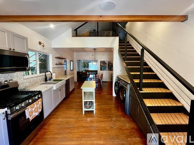 A kitchen with a stove top oven and a washing machine.