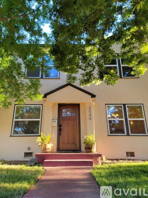 A house with a brown door and a sign that says "available" in front of it.