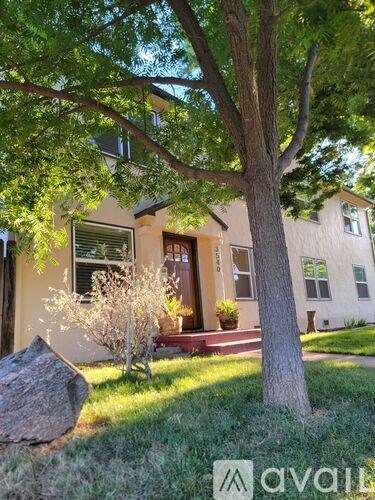 A house with a tree in front of it.