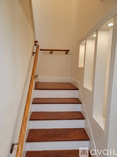 A staircase with wooden steps and a handrail.