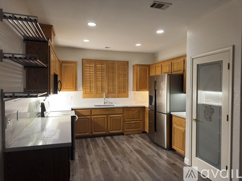 A modern kitchen with wooden cabinets and stainless steel appliances.