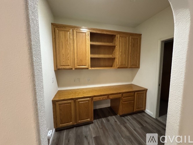 A room with wooden cabinets and a desk.