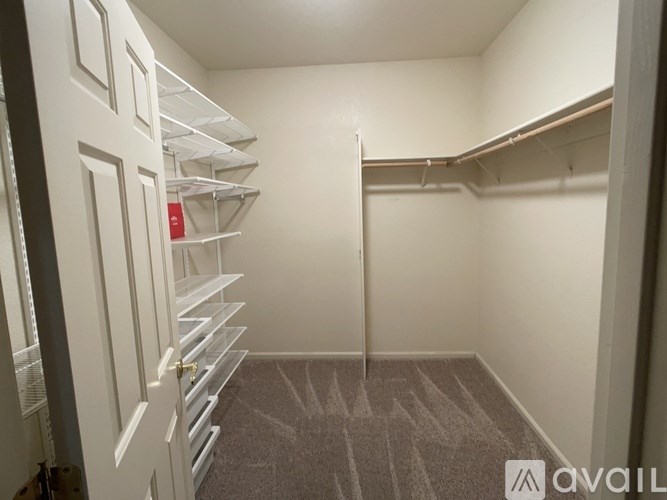 A small, empty room with a carpeted floor and white walls.