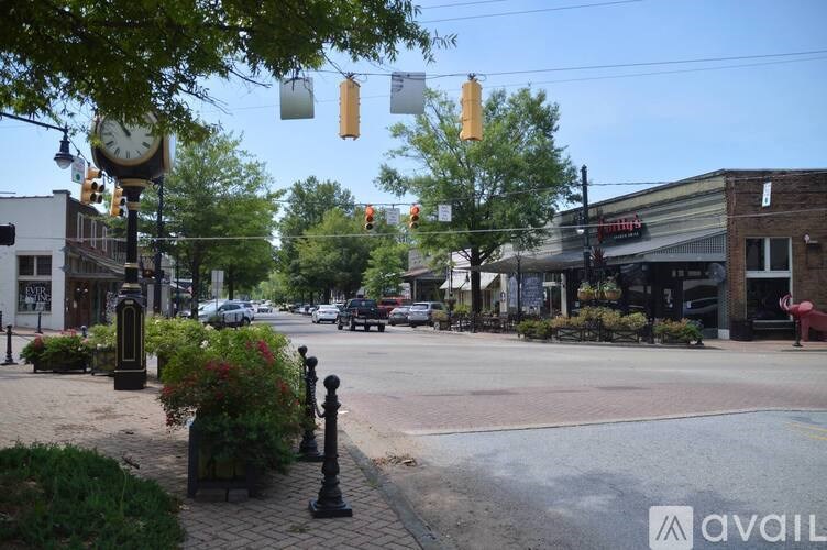 A street view with a clock tower and a crosswalk.