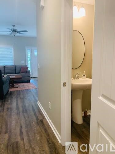 A living room with a couch and a ceiling fan.