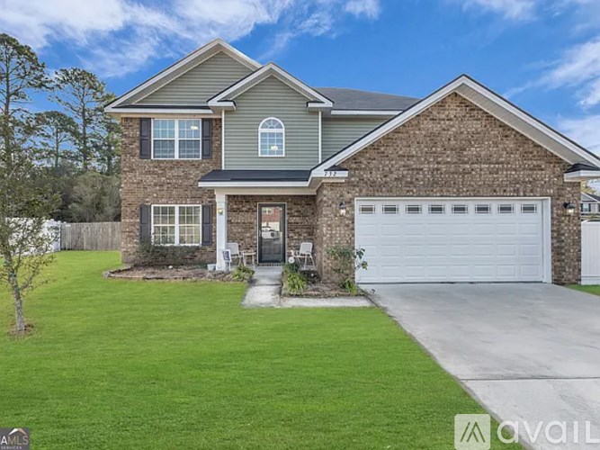 A house with a grey roof and a white garage door.