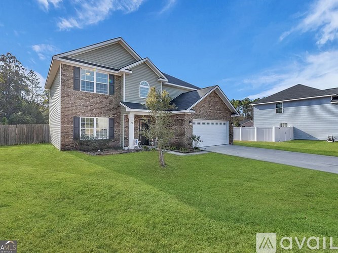 A house with a garage and a driveway is for sale.