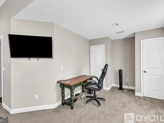 A room with a desk and chair in it.