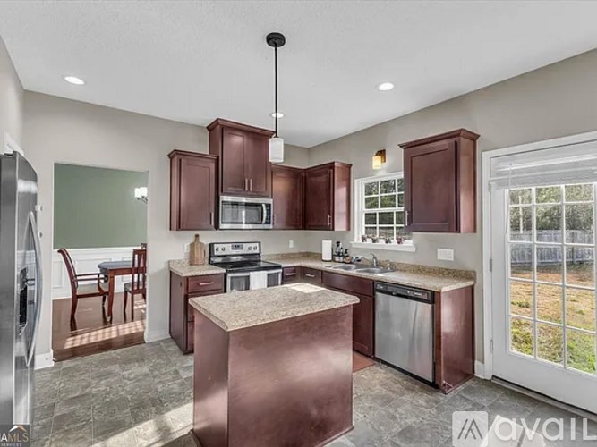 A kitchen with brown cabinets and a copper island.