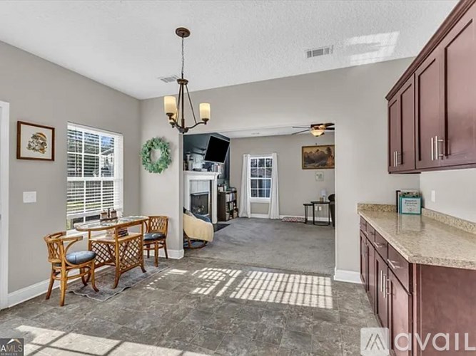 A kitchen with a dining table and chairs is available for rent.