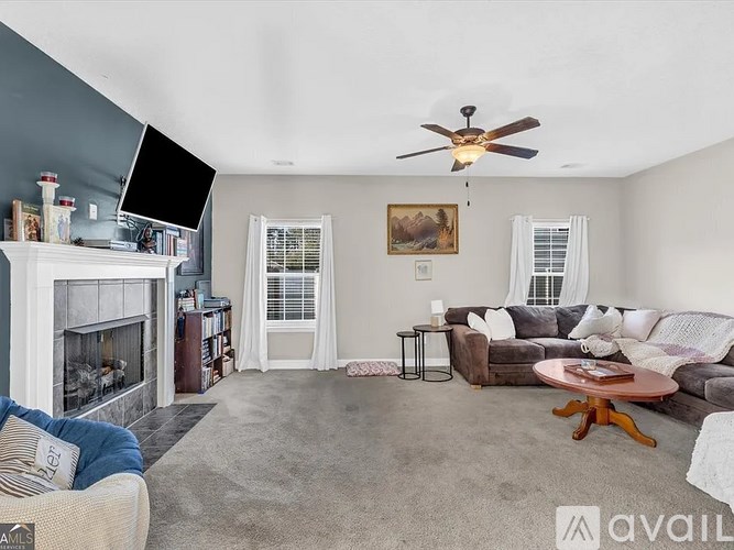 A living room with a fireplace, a couch, a chair, and a coffee table.