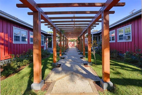 a covered walkway with wooden beams