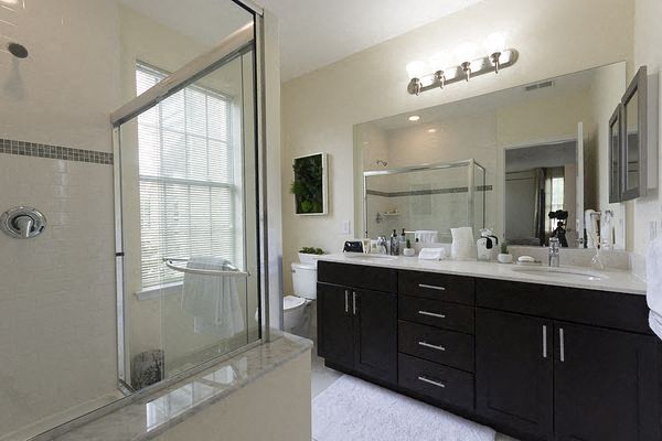 a bathroom with a shower and a sink and a mirror