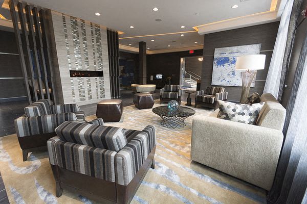 a large living room with chairs and a table